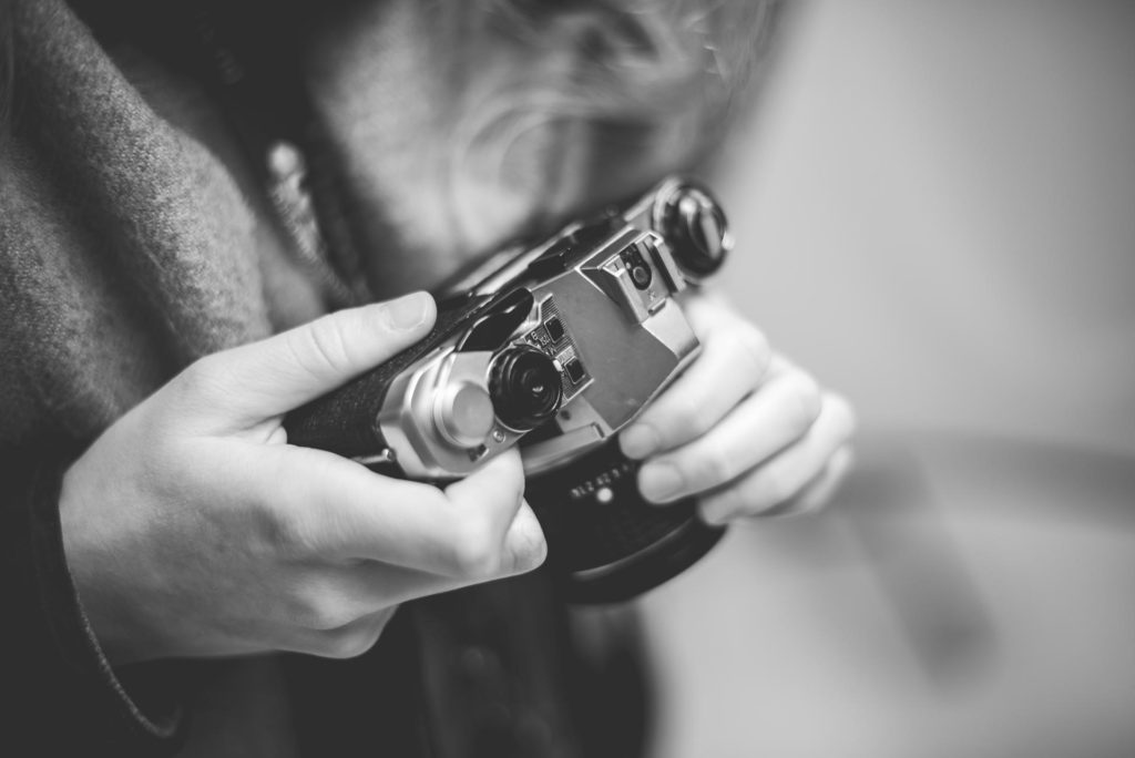 Person holding retro vintage movie camera