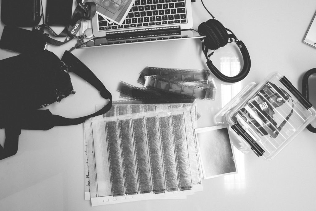 Desk with negatives, mac and headset