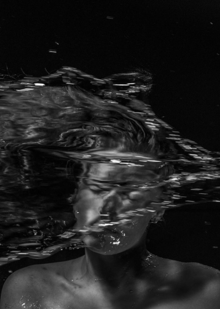 Studio photo of man getting water over his head
