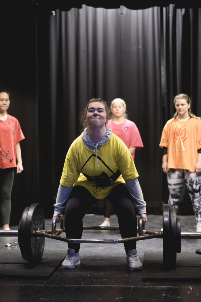 Young woman lifting weights