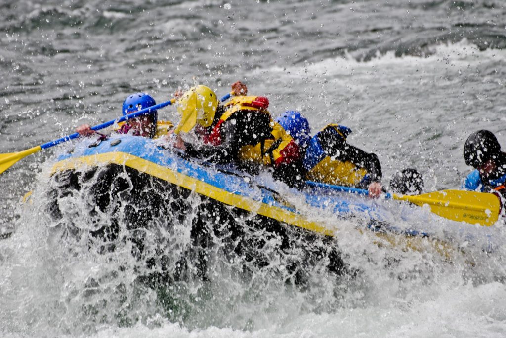 Rafting boat with a lot of splash from the river