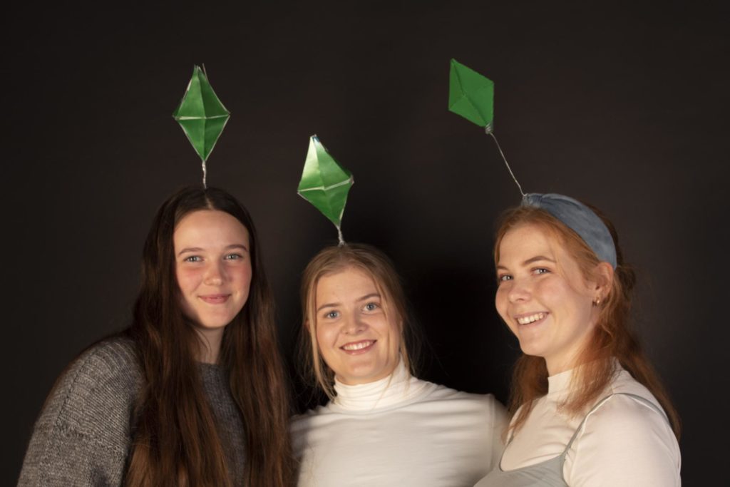 Tre unge kvinner har kledd seg ut som Sims