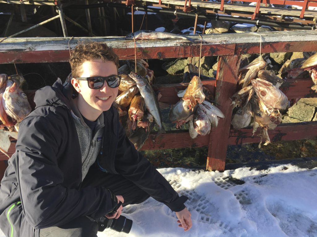 Young man posing with fish heads