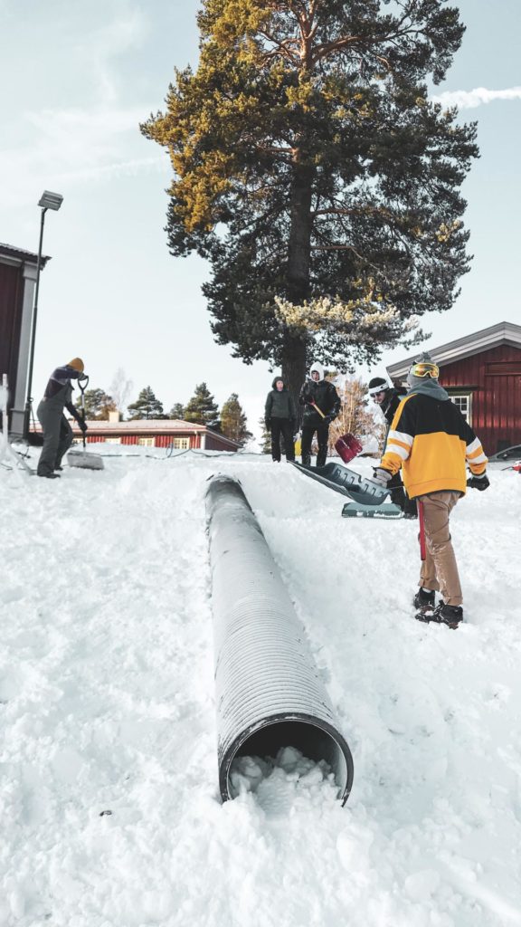 Students shovel snow in rail park