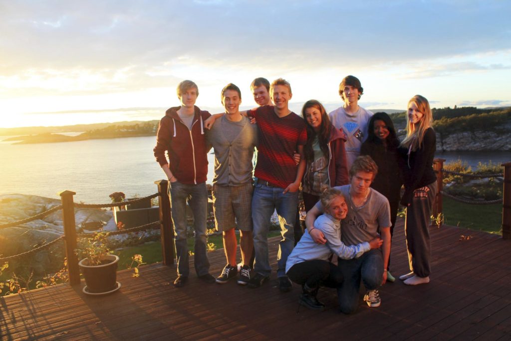 Gruppe unge mennesker i solnedgang