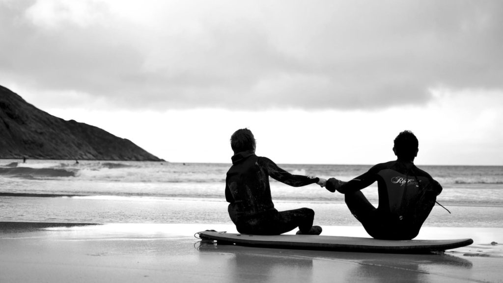 Surfers give each other the knuckle