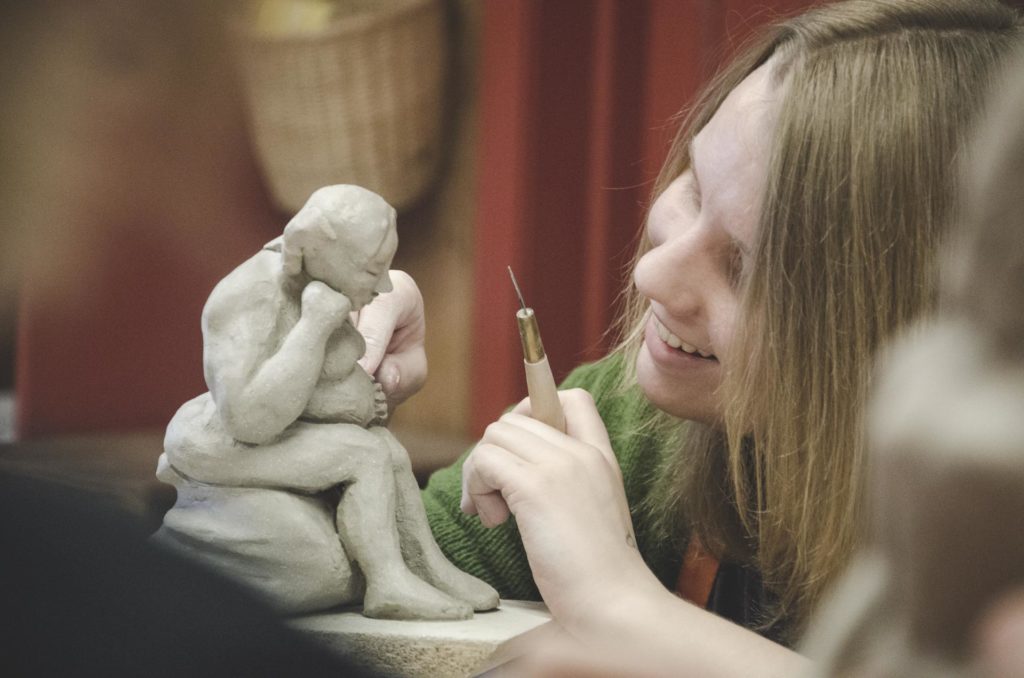 Young woman working with ceramics