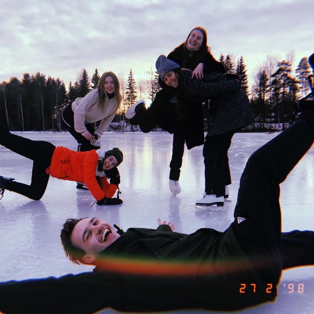 Young people pose and smile on skates