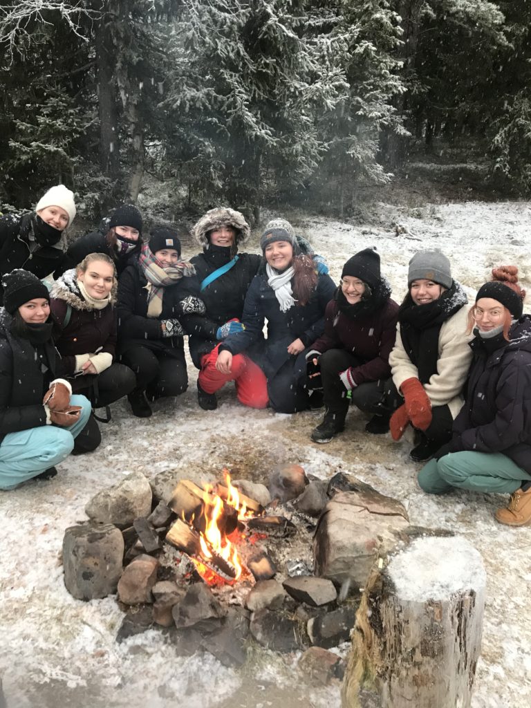Group sitting around campfire